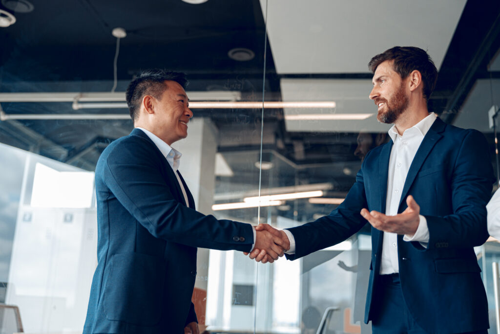 Business people handshaking while building professional network.