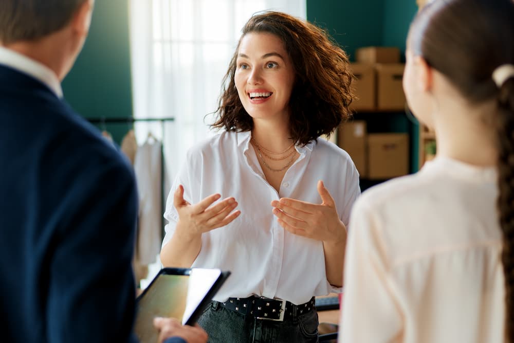 A brand representative talking to customers, symbolizing brand engagement.